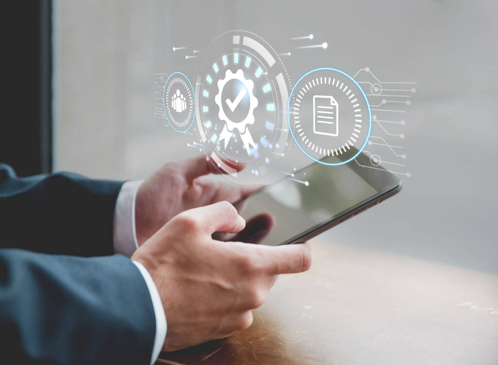 A person in a suit holds a tablet, with digital icons representing process automation and document management projected above the device.