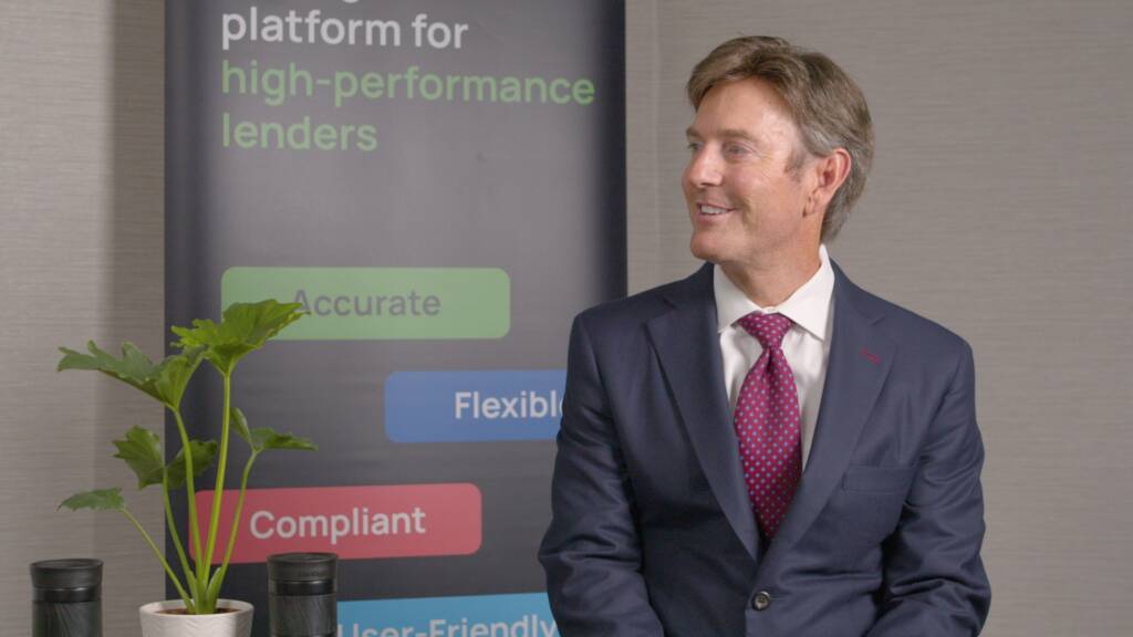 A man in a suit sits beside a potted plant, with a banner behind him displaying phrases about lending platforms, such as "Accurate," "Compliant," and "Flexible.